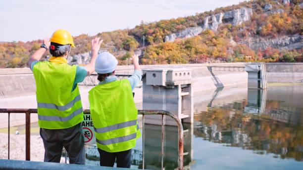 istock Maintenance engineers working in hydroelectric power station. Renewable energy systems. Gender blend. 1350848015