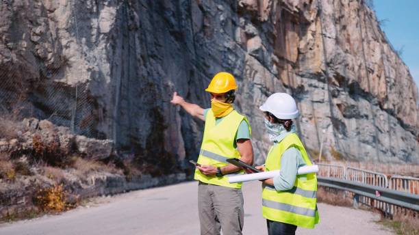 istock Road construction engineers working. Building new highways in COVID-19 pandemic. 1350848018