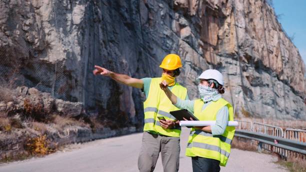 istock Road construction engineers working. Building new highways in COVID-19 pandemic. 1350848019