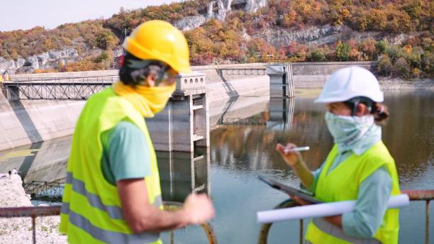 istock Maintenance engineers working in hydroelectric power station. Renewable energy systems. Gender blend. 1350848032
