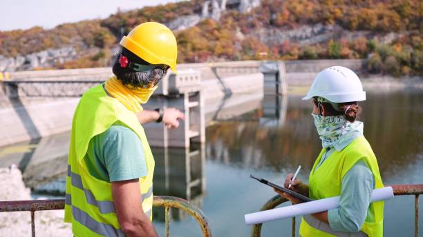 istock Maintenance engineers working in hydroelectric power station. Renewable energy systems. Gender blend. 1350848035