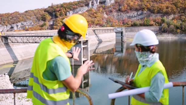 istock Maintenance engineers working in hydroelectric power station. Renewable energy systems. Gender blend. 1350848036