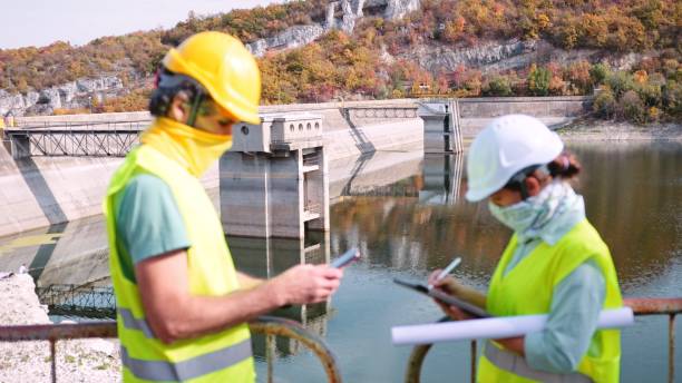 istock Maintenance engineers working in hydroelectric power station. Renewable energy systems. Gender blend. 1350848038