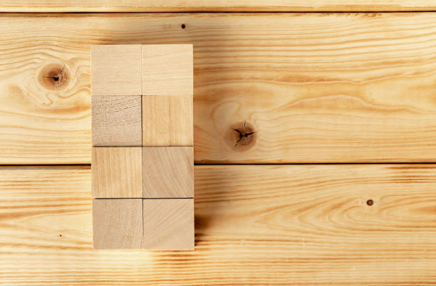 groupped wooden square blocks on dark wooden table - groupped imagens e fotografias de stock
