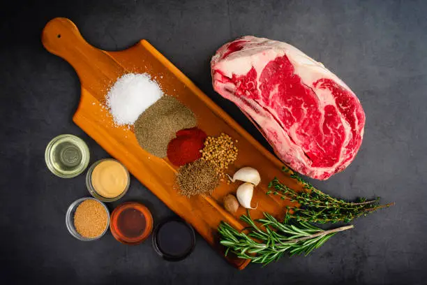 Uncooked beef rib roast with spices and other ingredients