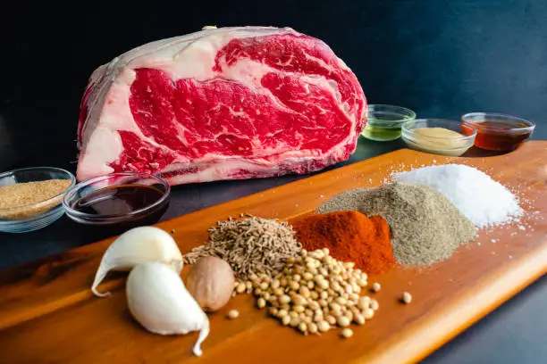 Uncooked beef rib roast with spices and other ingredients