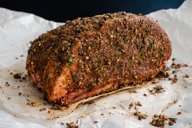 Uncooked rib roast covered in a spice rub