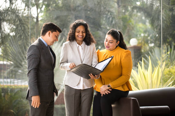 istock Business colleagues discussing over filed reports at office 1350853106