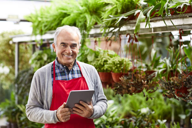 istock Owner with digital tablet working in plant nursery 1350853171