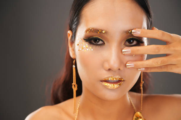 istock Beautiful Woman with Golden Make-up 1350853191