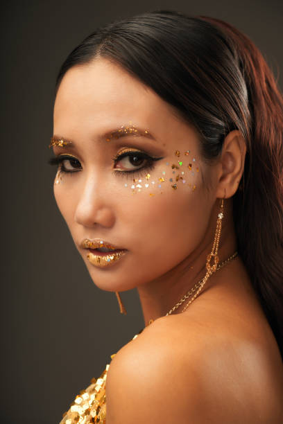 istock Gorgeous Woman with Golden Makeup 1350853193