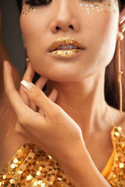 istock Young Woman with Golden Makeup 1350853194