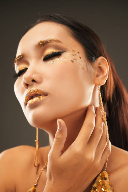 istock Attractive Woman with Golden Makeup 1350853198