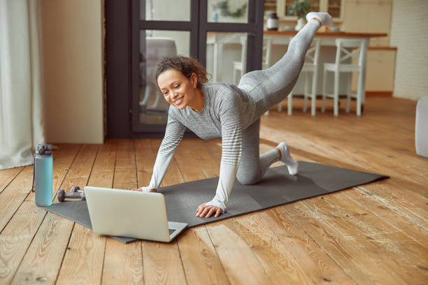 istock Smiling woman doing online training at home 1350853354