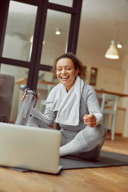 istock Cheerful female training with notebook at home 1350853357