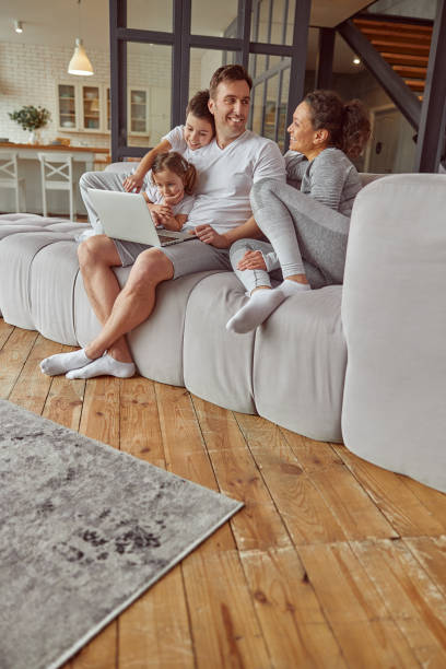 istock Cheerful family spending time with notebook at home 1350853399