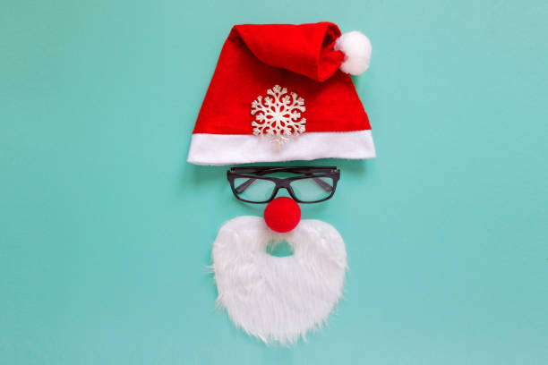 istock Santa Claus hat beard on green paper background 1350855535
