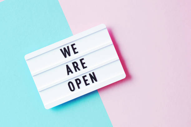 istock We Are Open Written White Lightbox Sitting On Pink And Blue Background 1350855647