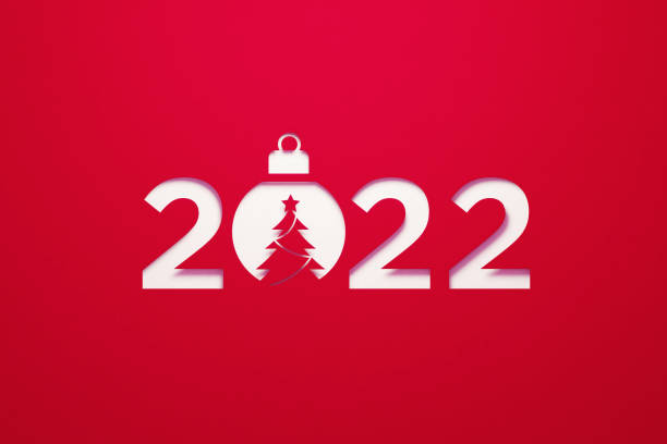 istock Christmas Concept-  2022 Sitting Next To A Christmas Bauble on Red Background 1350855659