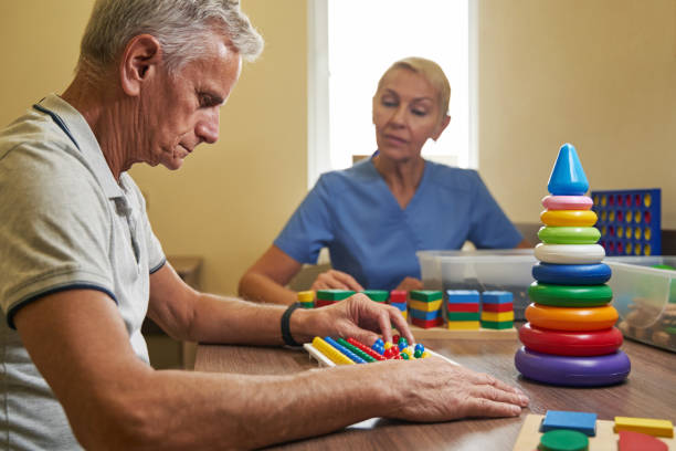 istock Mature patient using physiotherapy equipment for brain exercise in clinic 1350856919