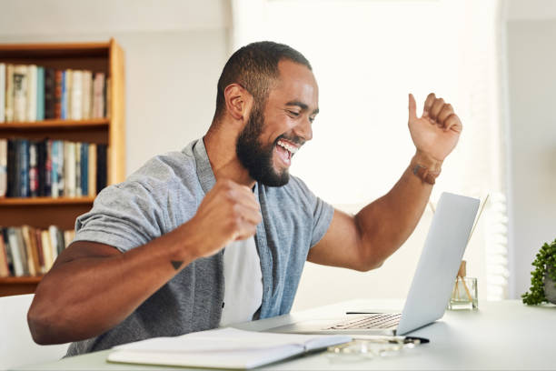 istock Shot of a handsome businessman looking excited while working from home 1350857611