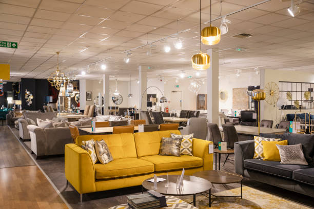 Luxury Furniture Goods A wide angle of a furniture store with no people in. There is various different sofas and lamps and furniture on the shop floor for display purposes. household products stock pictures, royalty-free photos & images