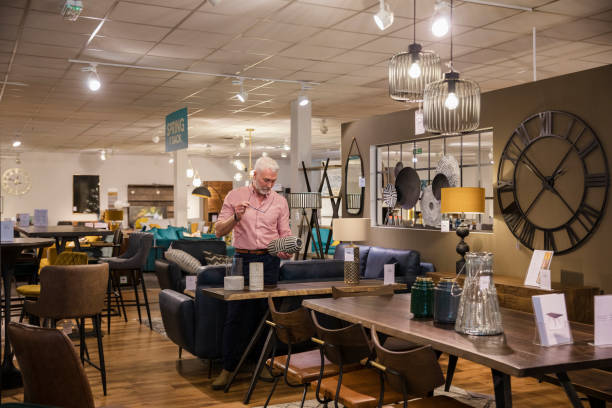 A wide-angle view of a store manager checking the merchandising in the department stor e he manages in Newcastle upon Tyne in the North East of England and making sure everything is correct.