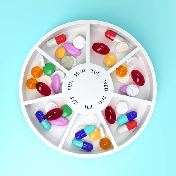 Round pill box with different tablets and vitamins for a week. Medication organiser. Top view. 3d rendering.