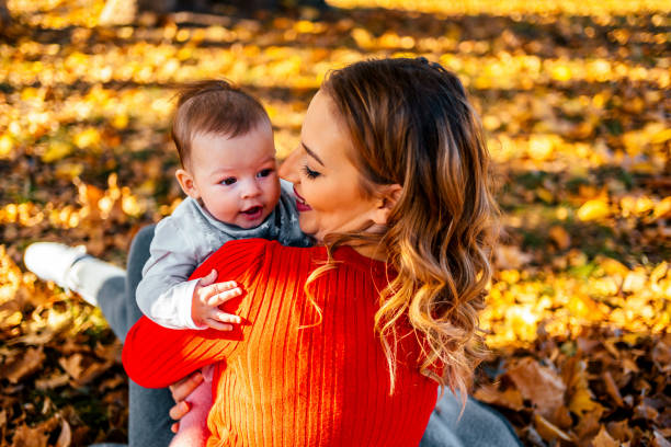 istock Mother with baby in the park 1350864362