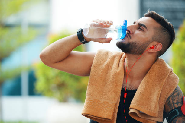 istock Thirsty Sportsman Drinking Water 1350865224