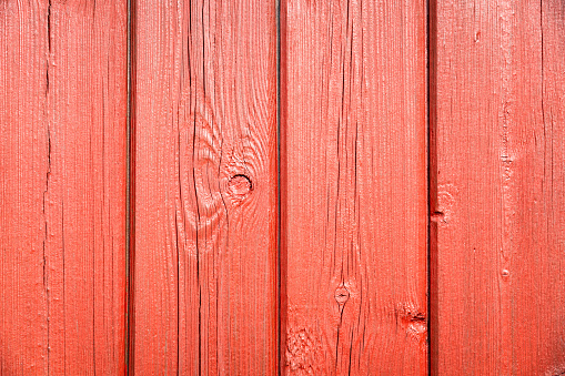 Planks of exterior wood, freshly painted in bright red.