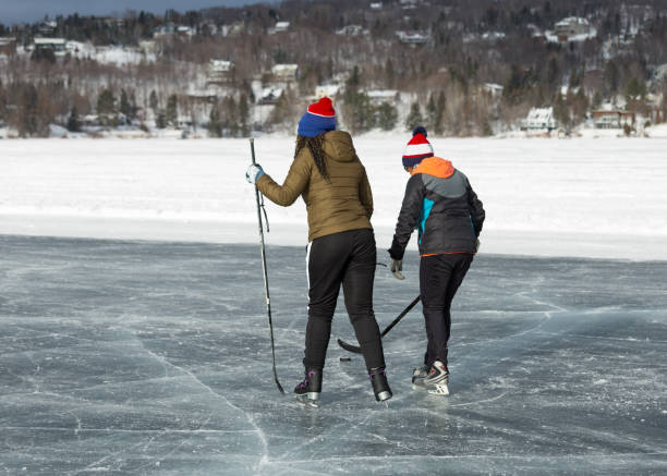 istock Playing hockey on frozen lake 1350866739