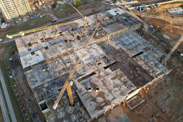 istock Pouring concrete from mixer truck. Tower crane on formwork at construction site. Reinforced concreting. 1350867359