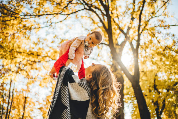 istock Mother and daughter having fun in the park 1350867364