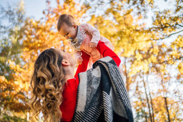 istock Mother and daughter having fun in the park 1350867398