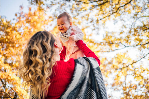 istock Mother and daughter having fun in the park 1350867734