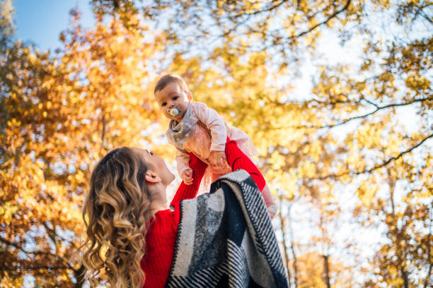 istock Mother and daughter having fun in the park 1350867780