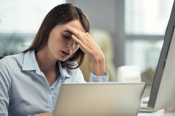 istock Woman With Headache Working In Office 1350867977