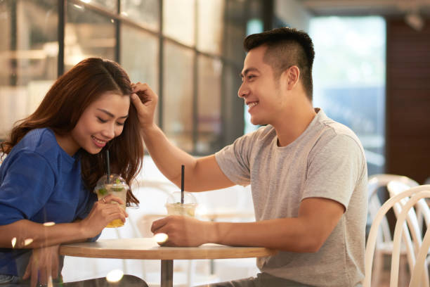 istock Young Man Adjusting Hair To Girlfriend 1350869258