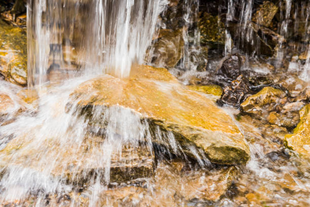 Part of moving water falling on the rock, beautiful waterfall