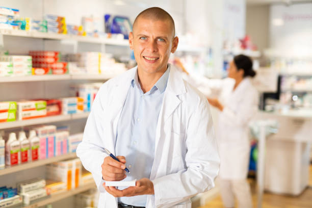 istock Pharmacist standing in drugstore 1350876187