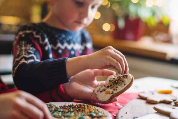 istock Little boy cooking Christmas cookies at the kitchen 1350876336