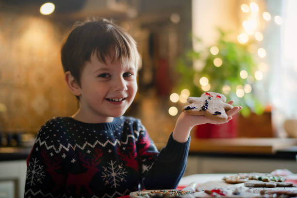 istock Little boy with Christmas cookies at the kitchen 1350876437