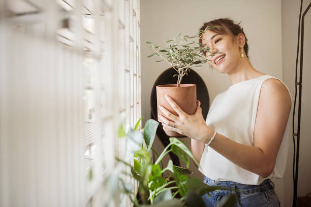 istock Asian Woman looking at plants 1350877296