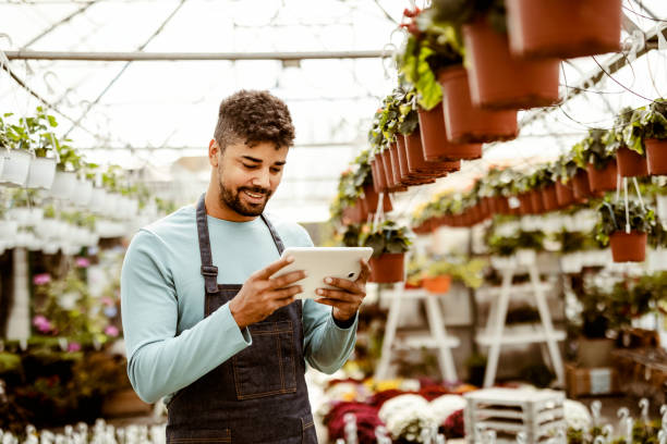 Using his tablet to manage the garden center