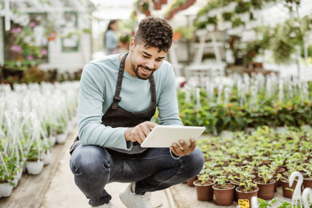 istock Using his tablet to manage the garden center 1350877964