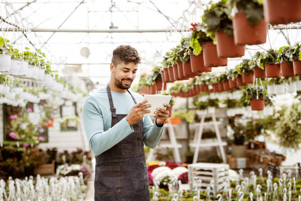 istock Using his tablet to manage the garden center 1350877973