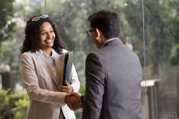 istock Business people shaking hands at office 1350878148