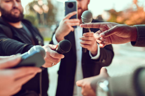 istock African Male Pointing While Giving Statement For Journalists Outside 1350882914