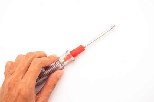 hand holding screwdriver isolated on a white background